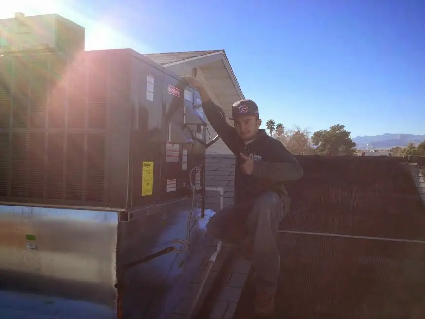 HVAC technician performing HVAC Inspection on a rooftop unit in Bellingham